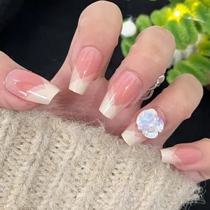 French tip press-on nails with 3D white flower design and pearl accents on nude pink base