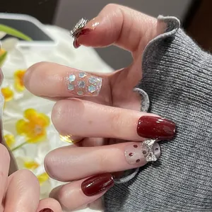 Cat-eye glitter false nails with red polka dots and rhinestone butterfly accents