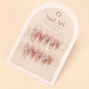 Long coffin press-on nails in nude pink gradient with 3D floral and butterfly charms