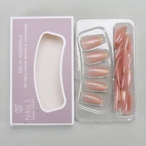 Detail of pink gradient press-on nails with gold glitter in windowed packaging