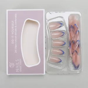 Detailed view of nude pink almond press-on nails with deep blue French tips and packaging