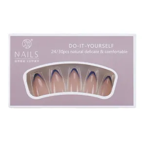 French tip press-on nails set with nude base and deep blue tips in clear window box