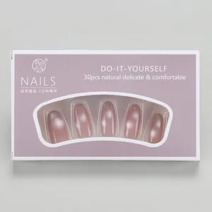 Detail of pink cat-eye press-on nails set in a grey-purple box with clear window