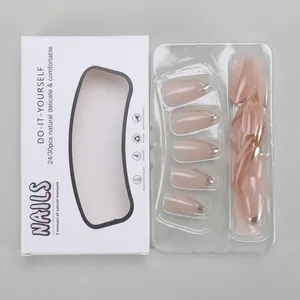 Detail view of almond nude pink press-on nails with silver French tips in a white gift box
