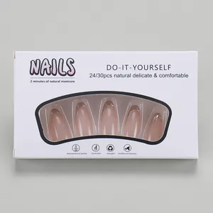 Detailed view of pink French press-on nails with gold edges in 24-piece retail packaging