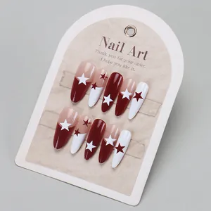 French press-on nails with burgundy and white star designs on elegant display stand