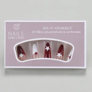 Macro detail of star pattern stiletto press-on nails in red and white kit