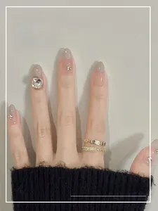 Macro detail of cat-eye gradient press-on nails with rhinestone accents and resin finish
