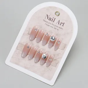 Handmade cat eye press-on nails with white gradient ombre and luxury rhinestone crystals