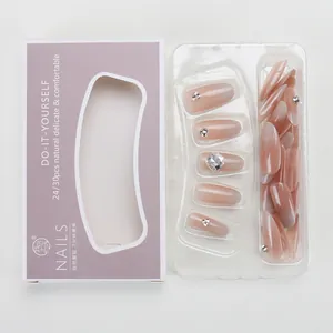 Cat-eye press-on nails set with nude pink gradient and rhinestone accents in packaging