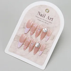 Unghie finte French rosa a mandorla fatte a mano con fiocchi e strass di lusso lucidi