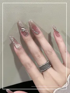 Detail of gradient pink cat-eye press-on nails with rhinestones and silver glitter