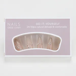 Detailed set of 24 press-on nails in almond shape with pearl and rhinestone accents