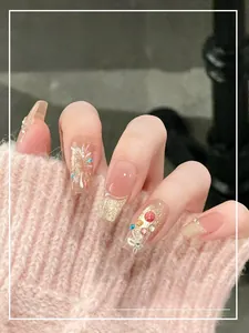 Detail of press-on nails featuring fireworks rhinestones and cat-eye pearl accents