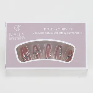 Detailed view of pink cat-eye press-on nails with silver rhinestones in lilac box