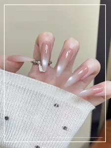 Macro detail of long almond-shaped cat-eye nails with soft pink to white gradient finish