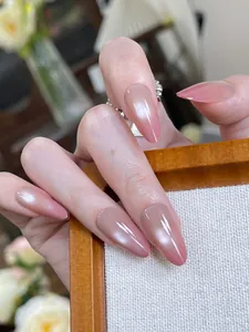 Detail of long almond press-on nails with cat-eye pink gradient and pearlescent finish