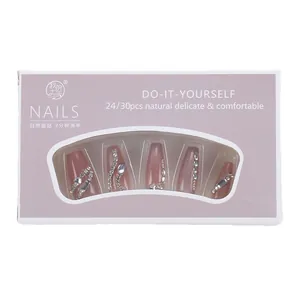 Cat eye gradient press-on nails with rhinestones and metal accents in retail box