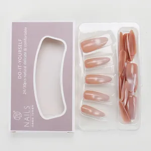 Detail of nude pink cat-eye press-on nails set with long stiletto shape in packaging