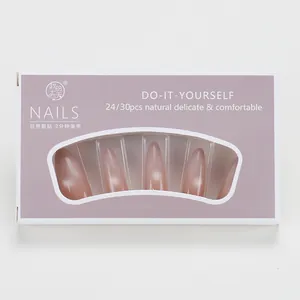 Macro detail of nude pink cat-eye press-on nails in long almond shape box packaging