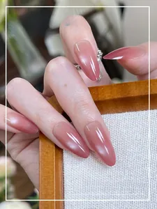 Detailed view of cat-eye almond press-on nails with soft pink gradient shimmer