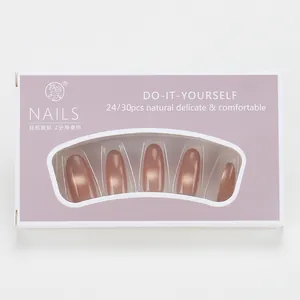 Close-up of caramel gradient press-on nails in rose gold finish with box packaging