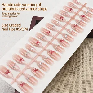 Handmade press-on nails set with nude cat-eye gradient and 3D red bows with silver rhinestones