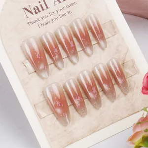 Close-up of almond cat eye press-on nails with pink gradient and shimmer texture