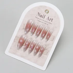 Detailed view of long almond cat-eye press-on nails with silver gradient and sequins