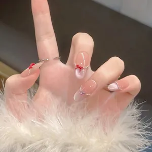 Handmade cat eye press-on nails in nude pink with 3D red bows and silver stripes
