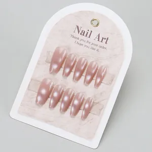 Handmade nude cat eye press-on nails in medium coffin shape on elegant display card