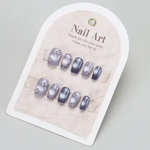 Cat eye handmade press-on nails with 3D floral accents and rhinestones on 10pc display