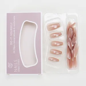 Macro detail of nude pink cat-eye press-on nails in trapezoid shape and purple packaging