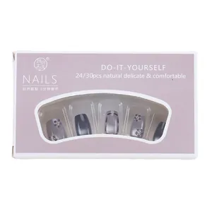 Blue cat-eye handmade press-on nails with 3D floral and pearl accents in white box
