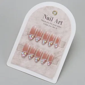 Handmade gradient pink press-on nails with heart accents and pearl decorations