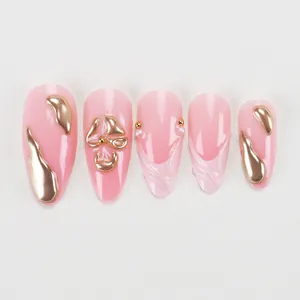 Pink almond press-on nails with 3D gold liquid metal flow and white pearl accents