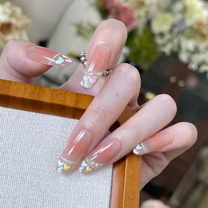 Handmade almond press-on nails with peach gradient, 3D colorful hearts and pearls