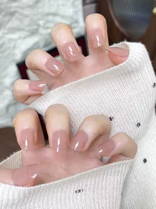Short square nude pink press-on nails with glossy jelly finish on hands