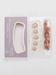 Short French blush nude press-on nails set in a purple box with 24 pieces in a tray
