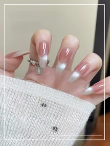 Close-up of French cat-eye press-on nails with silver pearl ring and lucky charm detail