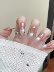 Detailed macro view of almond-shaped cat-eye nails with pink gradient and glossy finish