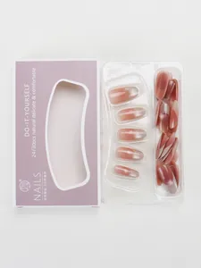 Macro detail of nude gradient press-on nails in purple packaging with transparent window