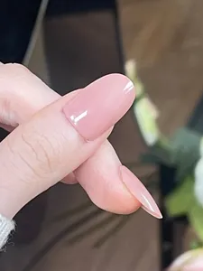 Macro shot of glossy nude pink square-round press-on nails for a natural polished look
