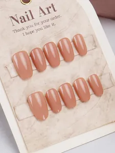 Macro shot of 10-piece glossy nude oval press-on nails on a textured brand display card