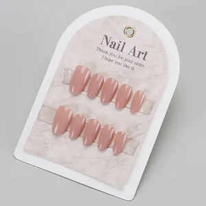 Glossy nude pink press-on nails set with mirror finish on marble display card