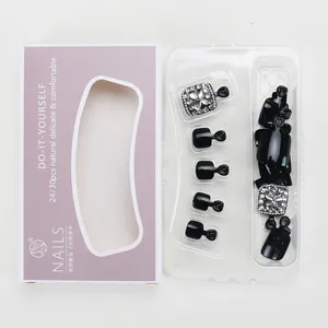 Elegant black french press-on toenails with sparkling diamond accents in storage box