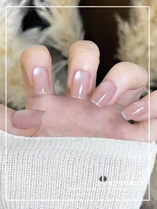 Detail of pink pearlescent press-on nails with silver French tips for a clean look