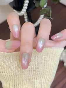Detail of pink and green gradient cat eye press-on nails with shimmering finish