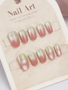 Macro view of pink and green gradient cat-eye press-on nails with silver glitter on display card