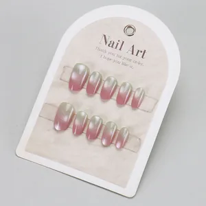 Pink and green gradient cat eye press-on nails set with silver glitter on display card